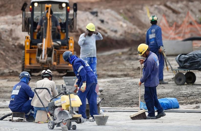 Construction workers outside the Olympic Park in Rio. President Dilma Rousseffu2019s impending trial wonu2019t affect preparations for the Olympics. (Net photo)
