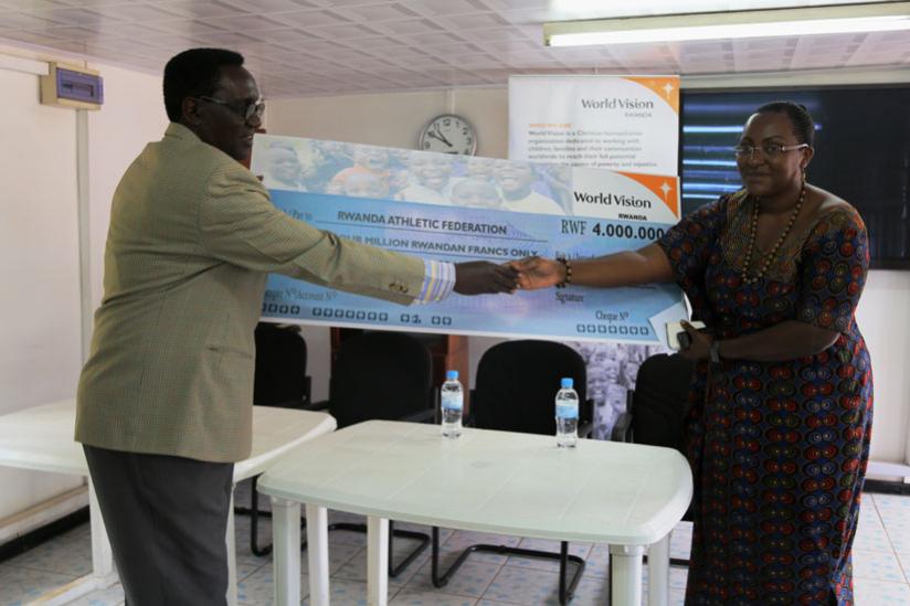 RAF Vice Chairman Kajuga receiving the Rwf 4 million cheque from Mukamugema, Programme Director at World Vision Rwanda.