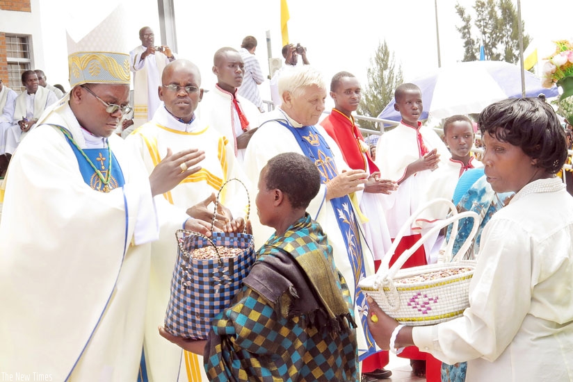 Christian faithful receive blessings as they offer alms at Kibeho Holy Land during the Assumption Mass last year. (File)