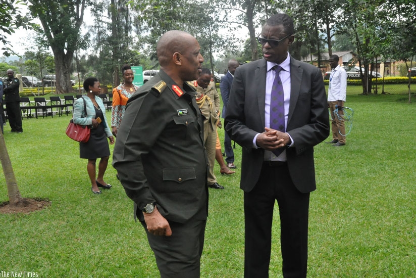 Kabarebe (R) chats with Gen. Patrick Nyamvumba shortly after opening the national security symposium in Musanze District, yesterday. (Courtesy)