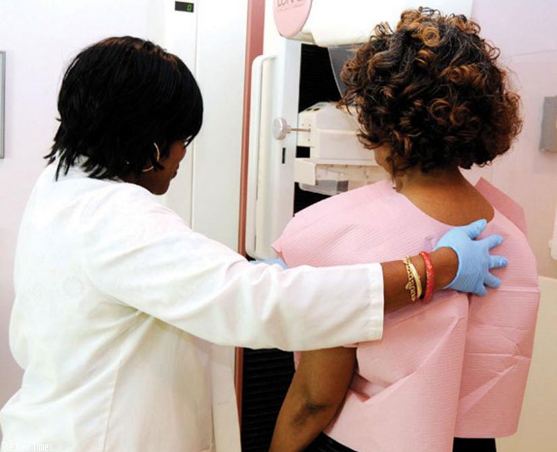 A woman gets screened for breast cancer. Net.