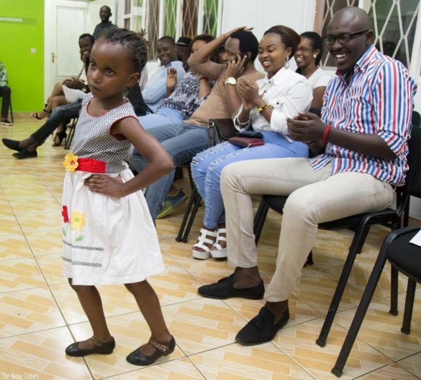A young model is applauded as she displays an African dress in Kigali last week. (File)