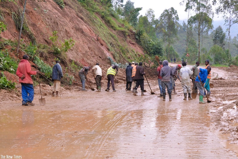 Gakenke residents remove mud from a road after heavy rains that left the road impassable. (Teddy Kamanzi)
