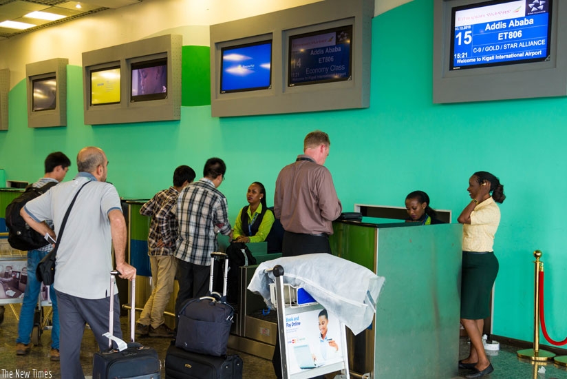Passengers check in at Kigali International Airport. (Timothy Kisambira)