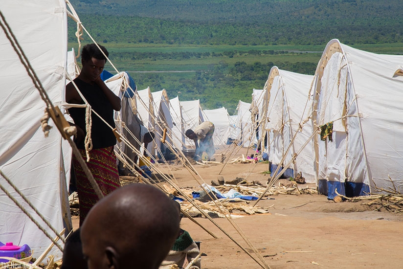 Burundian refugees prepare a meal at Mahama Camp. UNHCR wants more help for them. (Timothy Kisambira)