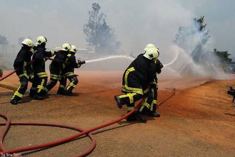 Fire and Rescue Brigade officers demonstrate how to put out a fire. (Courtesy)