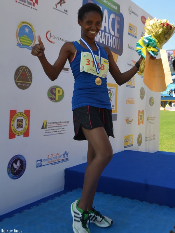 Salome Nyirarukundo celebrates her second position finish in the Kigali International Peace Marathon on Sunday. She has now set her sights on the Rio Olympic games. (S. Ngendahimana)