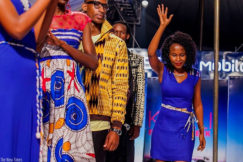 Joselyne Umutoniwase (waving) during this year's Kigali Fashion Week. (Internet photo)