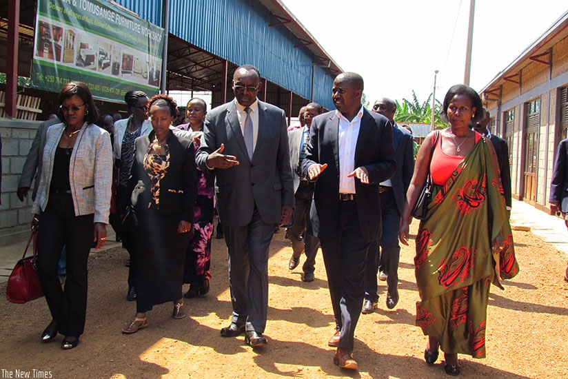 Kanimba (C) with other officials tour the new business centre in Kicukiro District after its inauguration. (Frederic Byumvuhore)
