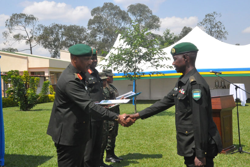 Top, Gen Nyamvumba awards a certificate to  a graduand. (Courtesy)