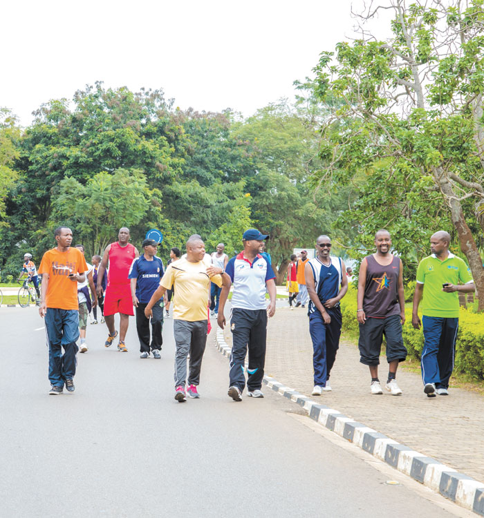 People from different places of Kigali walk in the KN 5 road without fear of cars yesterday. (Faustin Niyigena)