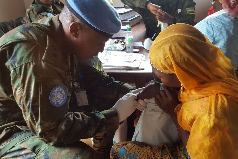 An RDF doctor vaccinates a child during the medical outreach last week. (Courtesy)