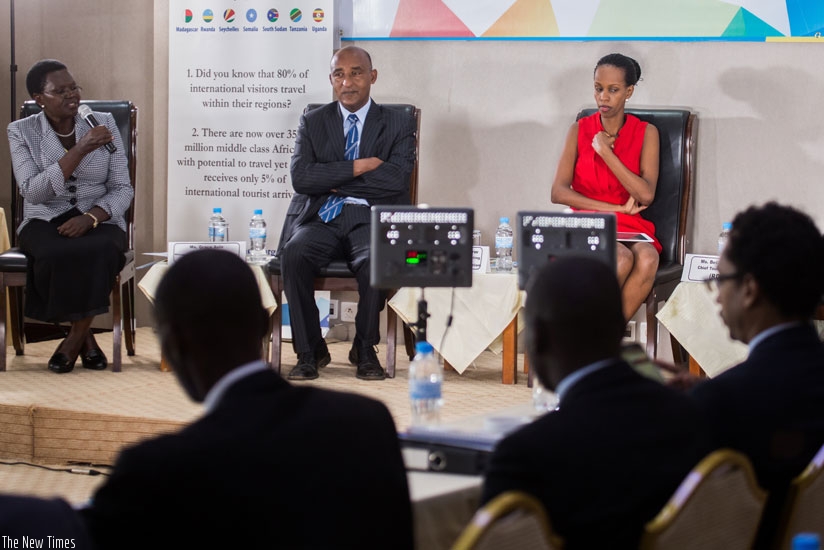 Aulo (L), Sisay Getachew, the marketing director of Ethiopian Tourism Organisation (C), and  Kariza during a panel discussion at the ongoing tourism regional meet. (T. Kisambira)