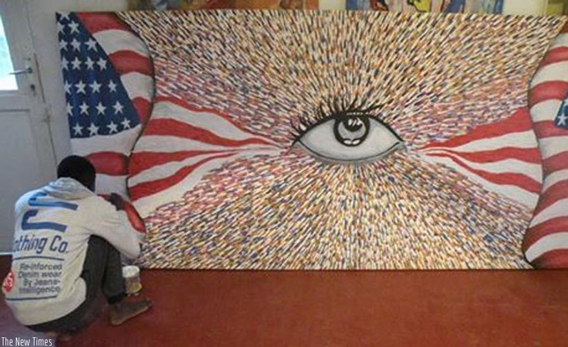 Ishimwe works on his 'I am american' painting.