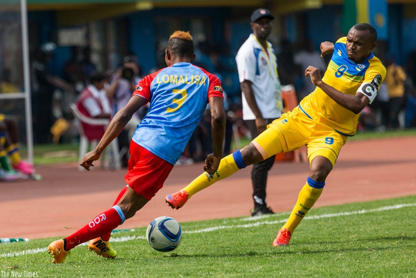Amavubi forward Jacques Tuyisenge (R) dribbles past Congolese Joyce Lomalisa during the 2016 CHAN tournament in Kigali. (File)