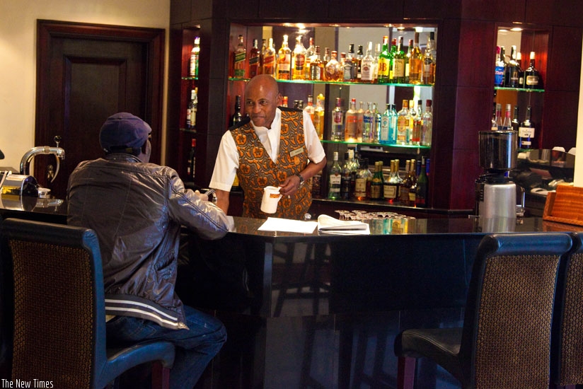 A barman attends to a client at the Kigali Serena Hotel. The hospitality industry is still wanting in customer service. (Timothy Kisambira)