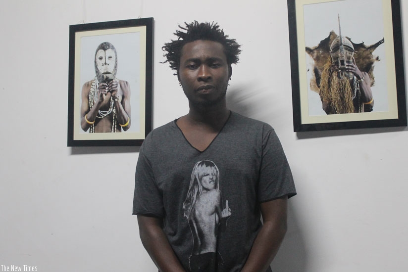 Nkinzingabo poses by some of his framed portraits. (Moses Opobo)