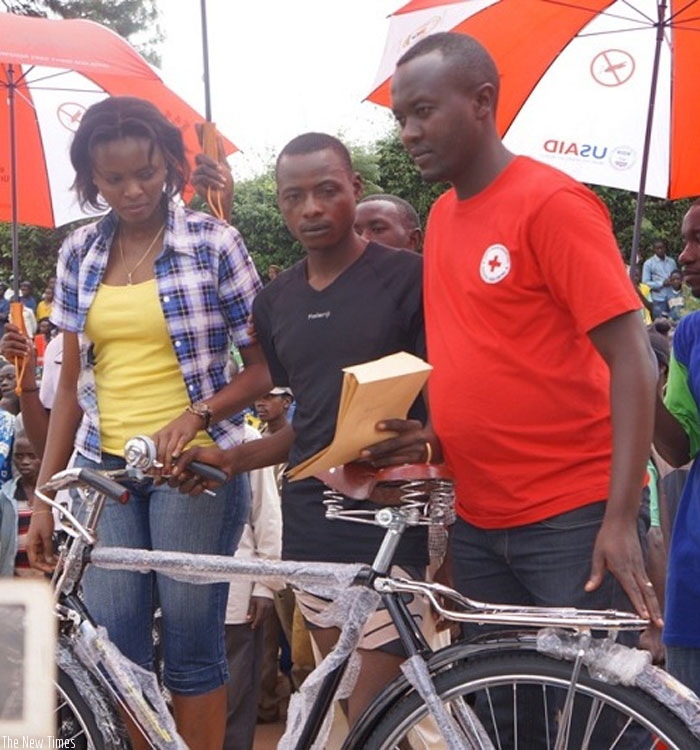 Jean Pierre Ahorukomeye (C) was awarded a new bicycle  after winning  the Gisagara race. (Courtesy)