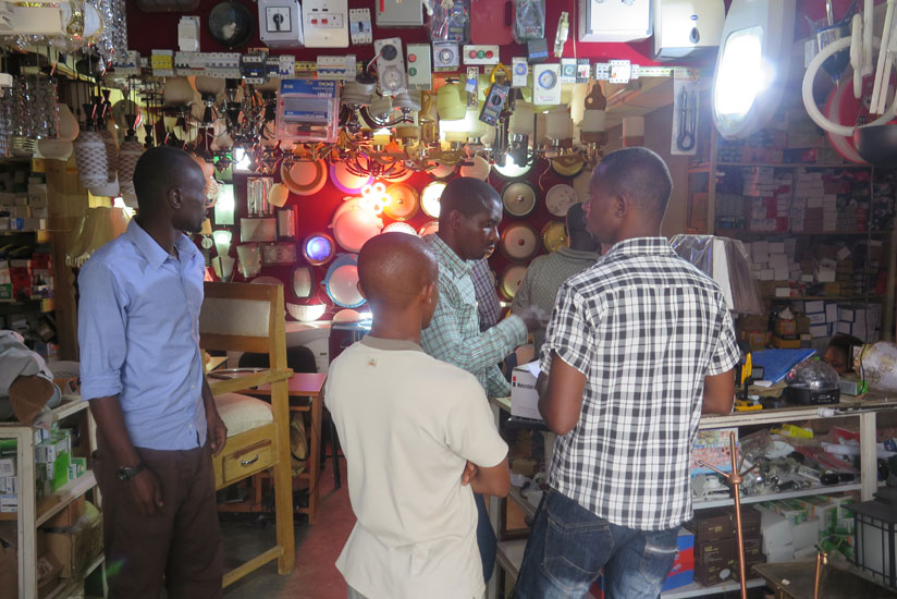 People buy items from an electronics shop. Young businesses need more creativity to thrive. (Solomon Asaba)