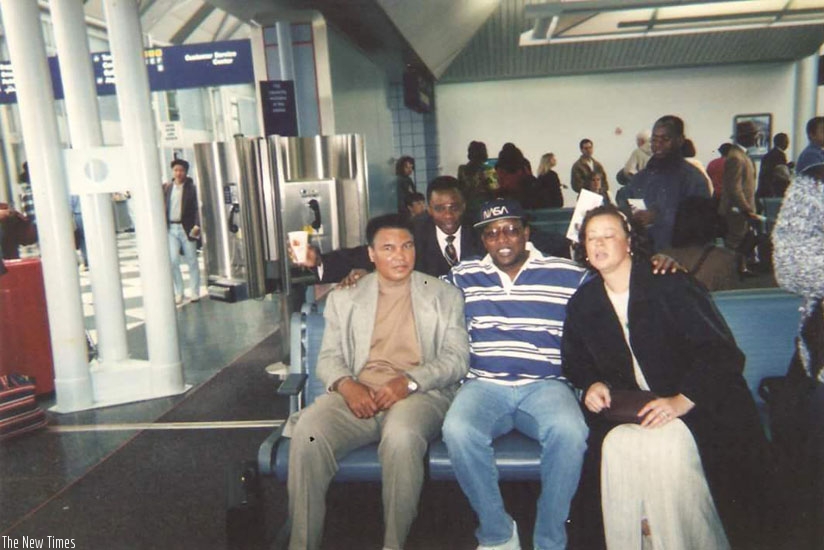 Ndoba Mugunga (C) poses for a photo with Muhammad Ali (L) and his wife (R) at an airport in the US in 1996. (Courtesy)