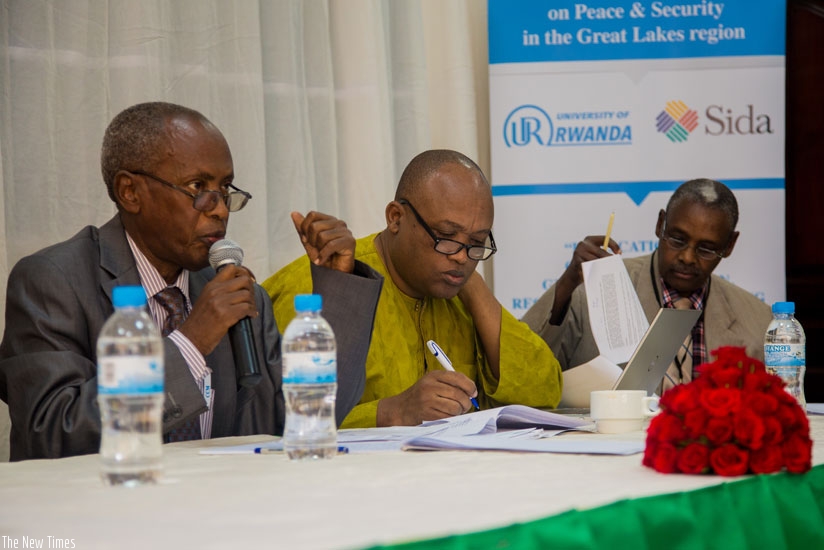 Prof. Nkusi (L) addresses participants as Ndahiro (C) and University of Rwanda don Dr Charles Gasarasi take notes at the conference in Kigali, yesterday. (Faustin Niyigena)