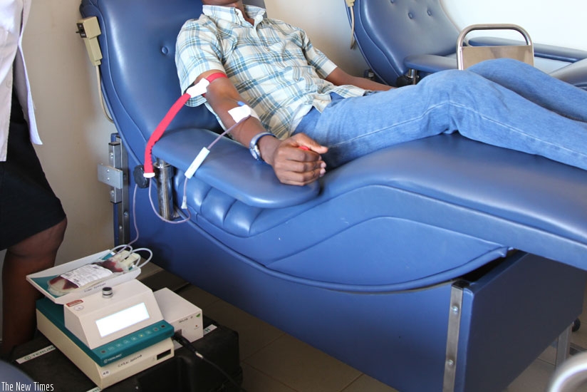 A man donates blood in Kigali. (Timothy Kisambira)