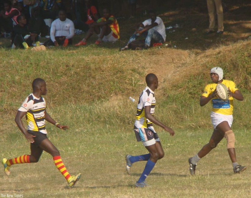 Jinja Hippos players close in on Lion de Fer winger Ignas Nsanzimana in the semifinals. Jinja went on to win the tourney. (S. Kalimba)