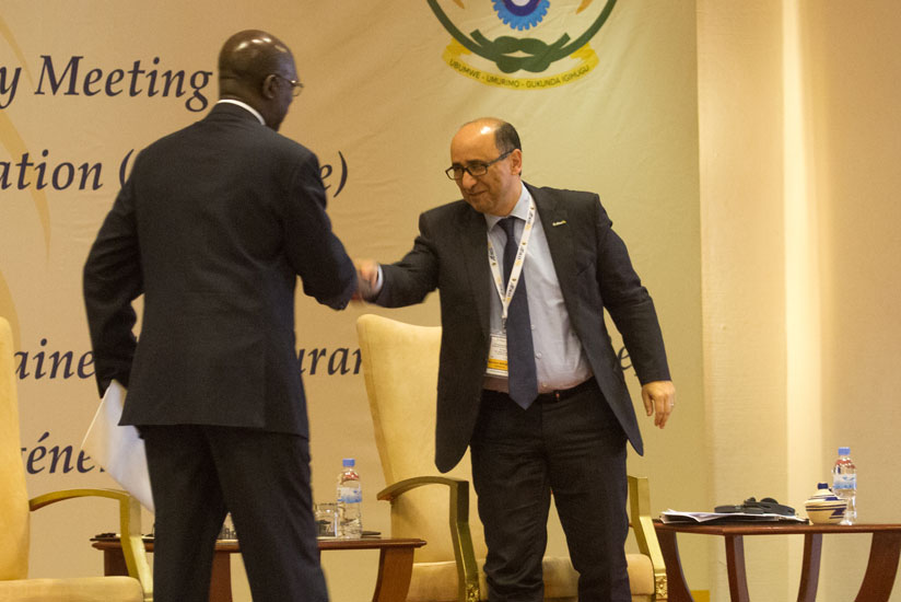 Murekezi( L) greets Boubrik at the symposium in Kigali yesterday. (T. Kisambira)