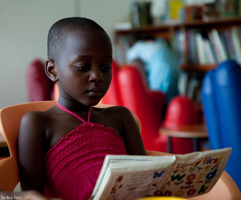 A child reads a book at the Kigali Public Library. (T.Kisambira)