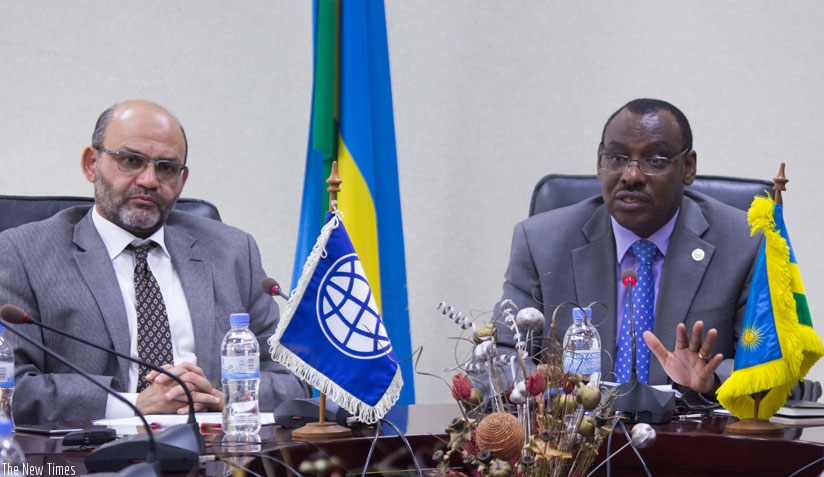 Finance minister Claver Gatete (R), addresses the media as Yasser El Gammal, the World Bank Country Manager for Rwanda looks on. (Timothy Kisambira)