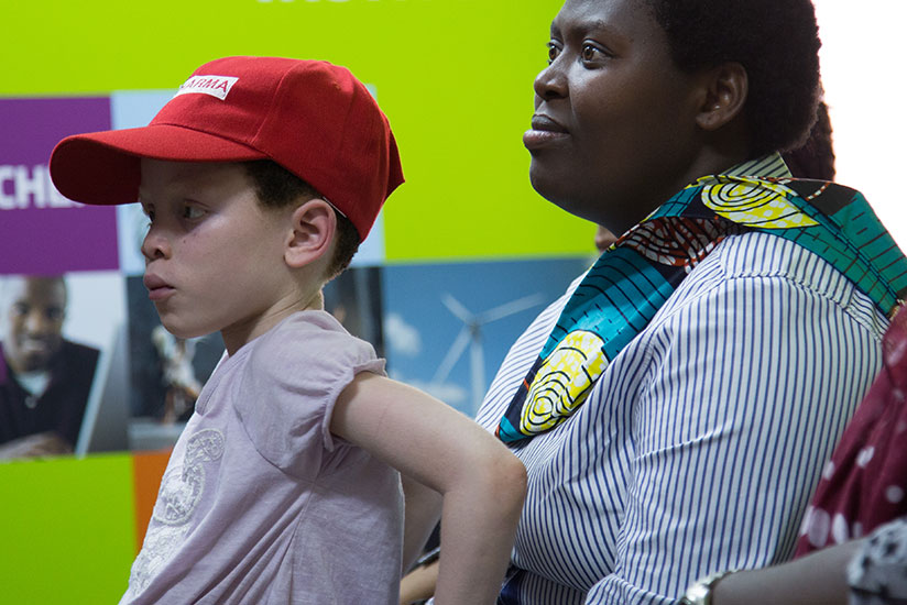 Rezke Hakimana with her daughter Fabiola who has Albinism watching the documentary 'A Place for Myself. Fabiola acted in the movie. 