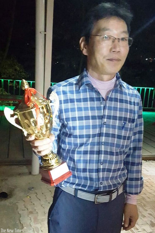 First runner-up Song Hochan posses with his trophy. The winner, Jong Kang, was not present at the awarding ceremony. (G. Asiimwe)