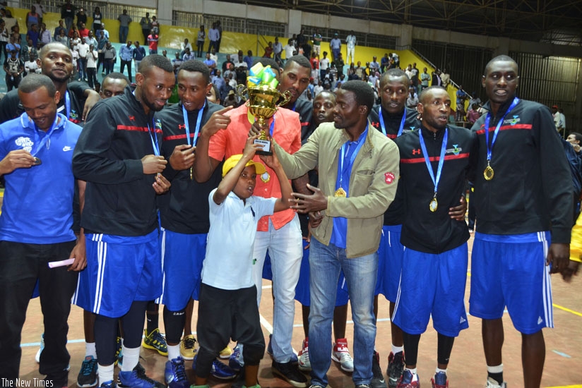 Patriots coach Mwinuka holds the trophy, along with his players after winning the 2016 Gisembe memorial regional title. (Sam Ngendahimana)