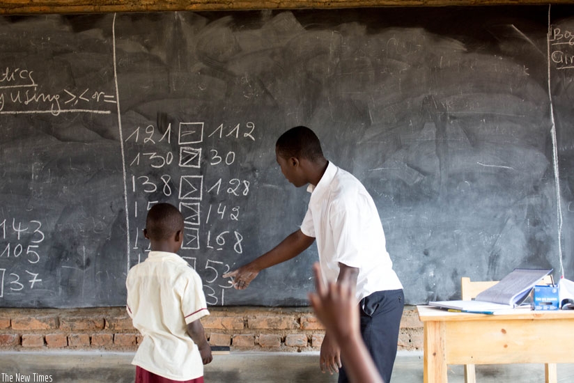 A teacher instructs a pupil at Rusheshe Primary school in Kicukiro district. (TKisambira.)