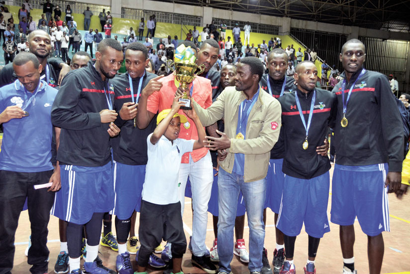 Patriots coach Mwinuka and players celebrate their recently won league title. (Courtesy)