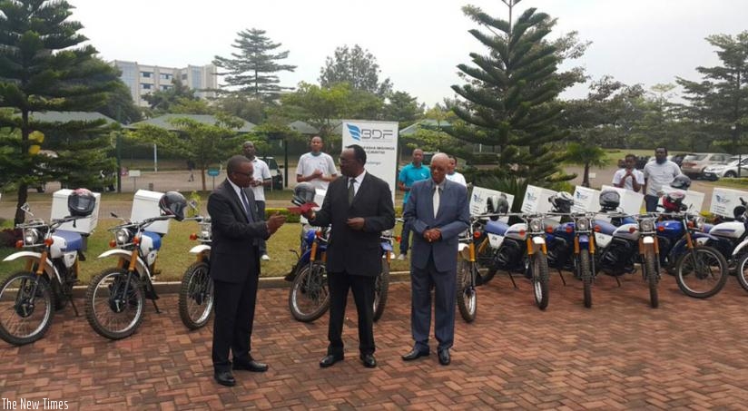 Kanimba (middle) chats with BDF chief (left) and another official at the event. (Peterson Tumwebaze)