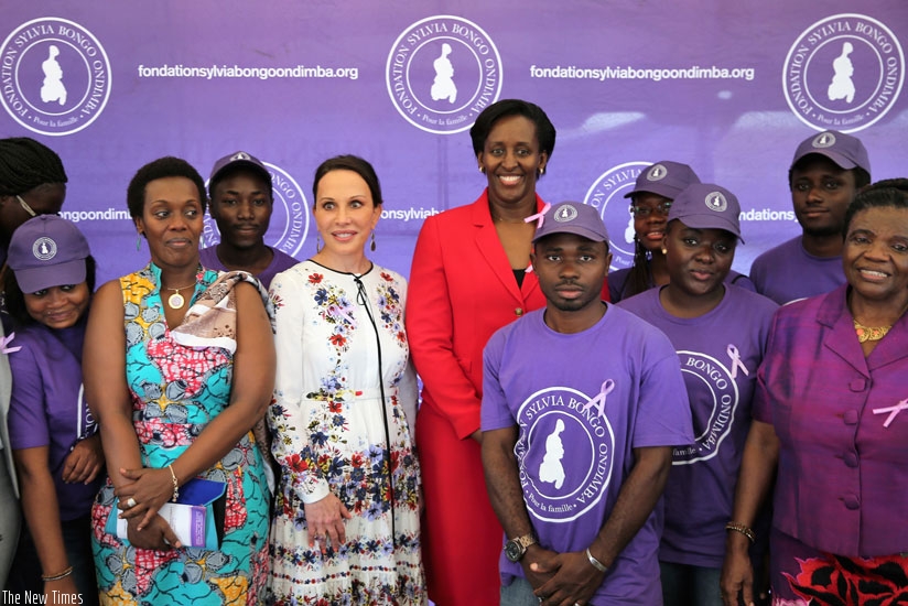First Ladies Jeannette Kagame and Sylvia Bongo of Gabon, Rwanda's Gender and Family Promotion minister Diane Gashumba (2nd left), pose with the staff of the Fondation Sylvia Ondimba Bongo during celebration of the International Day of Widows in Libreville yesterday. (Courtesy)