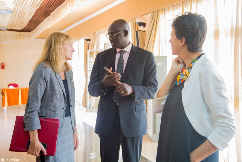 Minister Busingye (C) chats with Ambassadors Barks-Ruggles (L) and De Man during the release of action points to meet UN rights recommendations yesterday. (Faustin Niyigena)