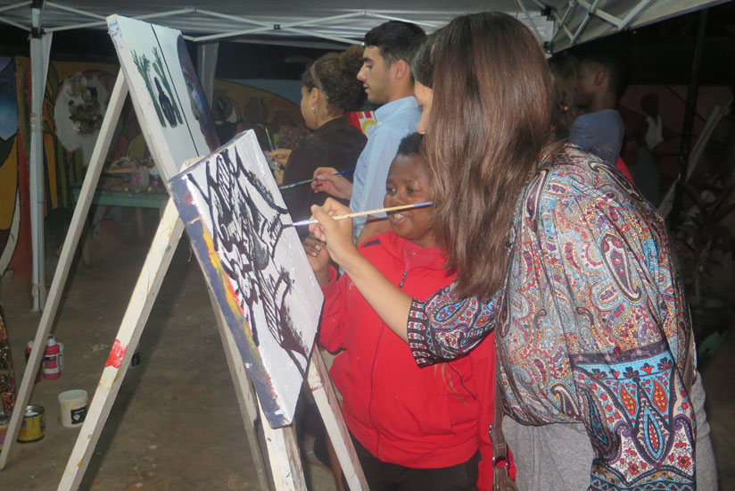 Fabian Akimana, the painting artist sharing some his painying skills. (Courtesy)