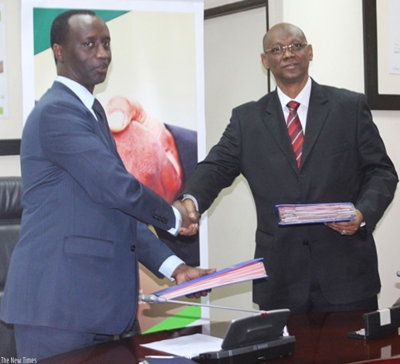 Kanyankole (left) and Diallo exchange the deal documents. (Appolonia Uwanziga)