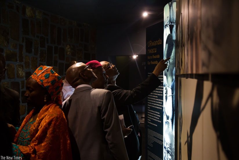 Visitors to Kigali Genocide Memorial Centre, Gisozi, look at  pictures pinned on the walls. (File)