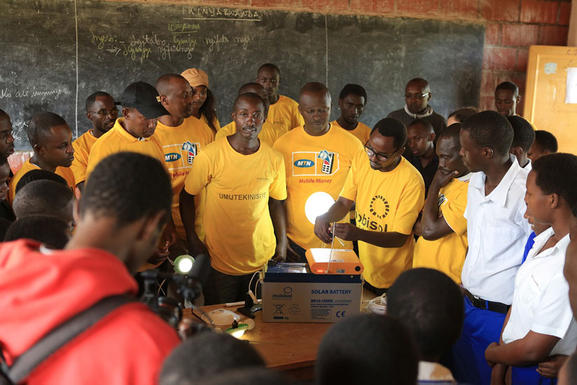 A Mobisol technician explains how a solar school system works during last year's Y'ello Care. (Courtesy)