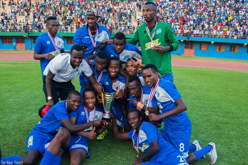 Rayon Sports players celebrate their victory with the Peace Cup trophy after beating APR FC 1-0 yesterday. (Nadege Imbabazi)
