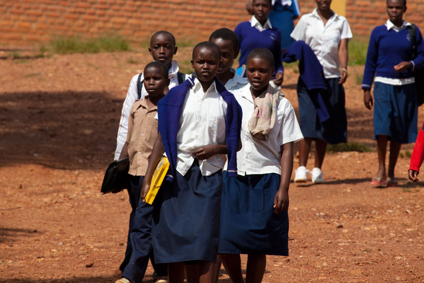 Students walking to school. Research shows that long distances to school affect students' concentration. (Timothy Kisambira)