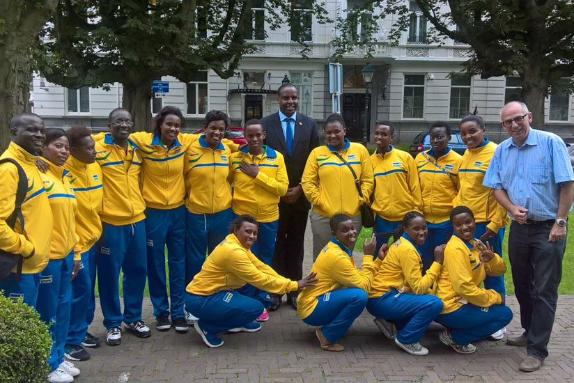 The team pose for a photo with Rwanda's ambassador to the Netherlands Jean-Pierre Karabaranga and head coach Peter Karreman. (Courtesy)