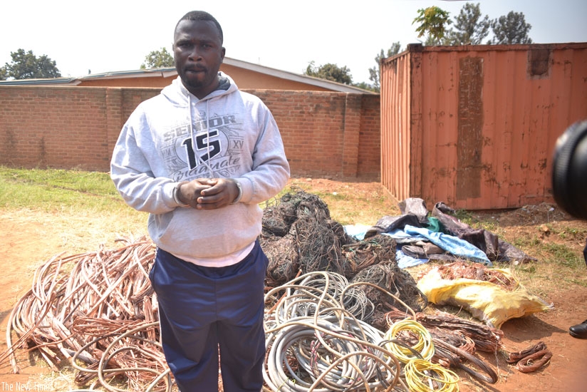 One of the suspects in the theft of electric cables (in the background), which he was found with. (Courtesy)