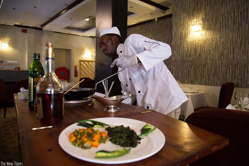 A chef prepares a meal at Karisimbi Hotel in Kigali. (Timothy Kisambira)