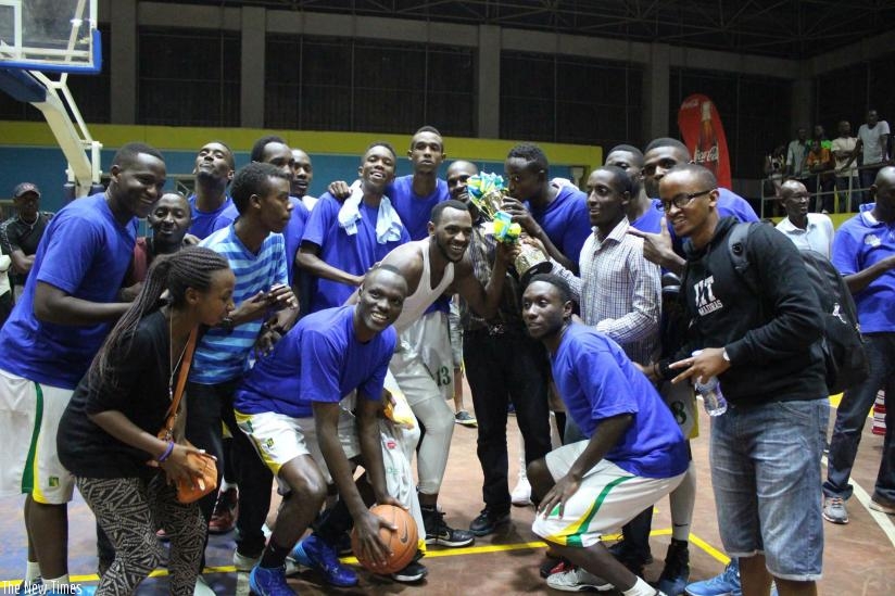 IPRC-South players celebrate with the trophy after winning the playoffs on Sunday night at Amahoro indoor stadium. (R. Bishumba)