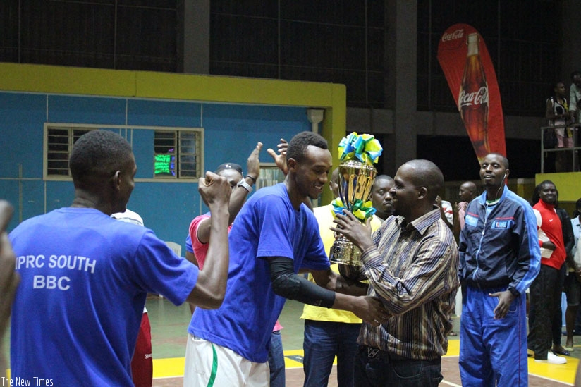 IPRC-South coach Charles Mushumba (R) and skipper Bienvenue Niyonsaba (L) celebrating with the trophy. (R. Bishumba)