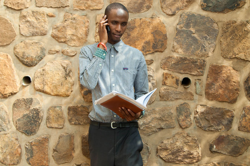 A student talks on phone. Research studies suggest that over-use of a cell phone can be disruptive to the learning process. / Francis Byaruhanga